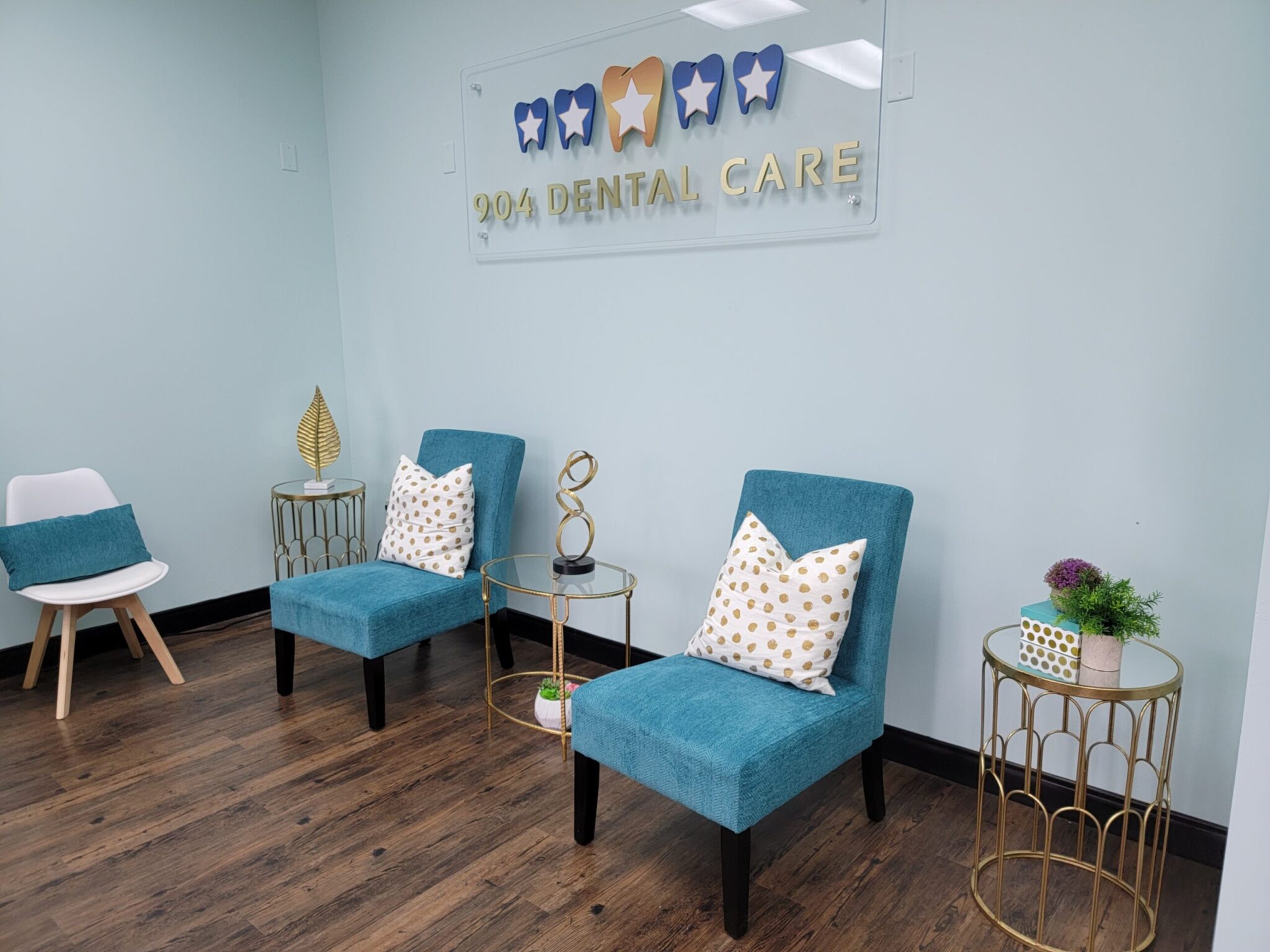 904 Dental Care. Patient Lounge with chairs and Office Wall Logo. All Services Under One Roof